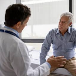 Doctor talking to a patient in clinical medical setting