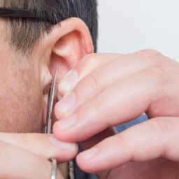 Man trims unwanted ear hair