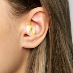 Close up of a woman wearing earplugs